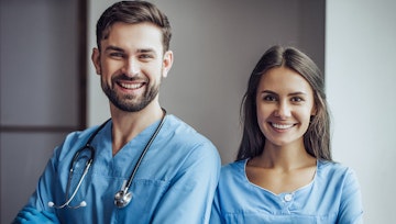 Male and female emergency vet smiling towards great business achievement